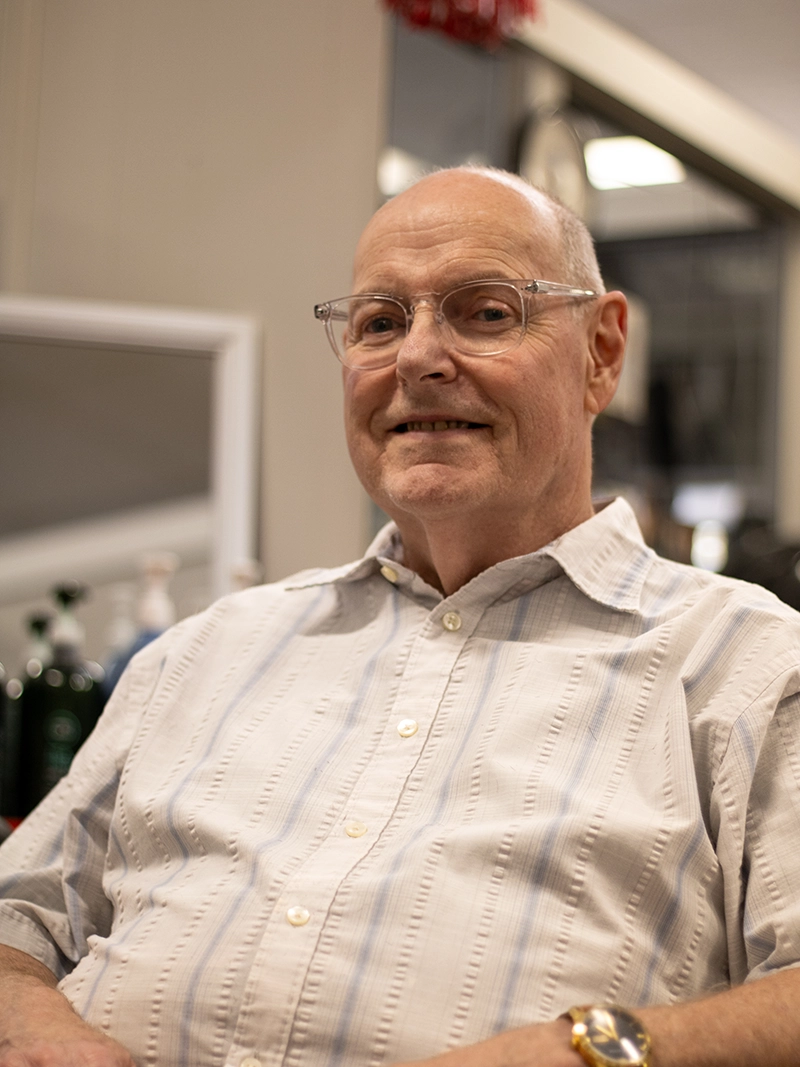 Portrait image of Dave. A barber at the Quaker Village Barber & Style Shop in Greensboro, NC.
