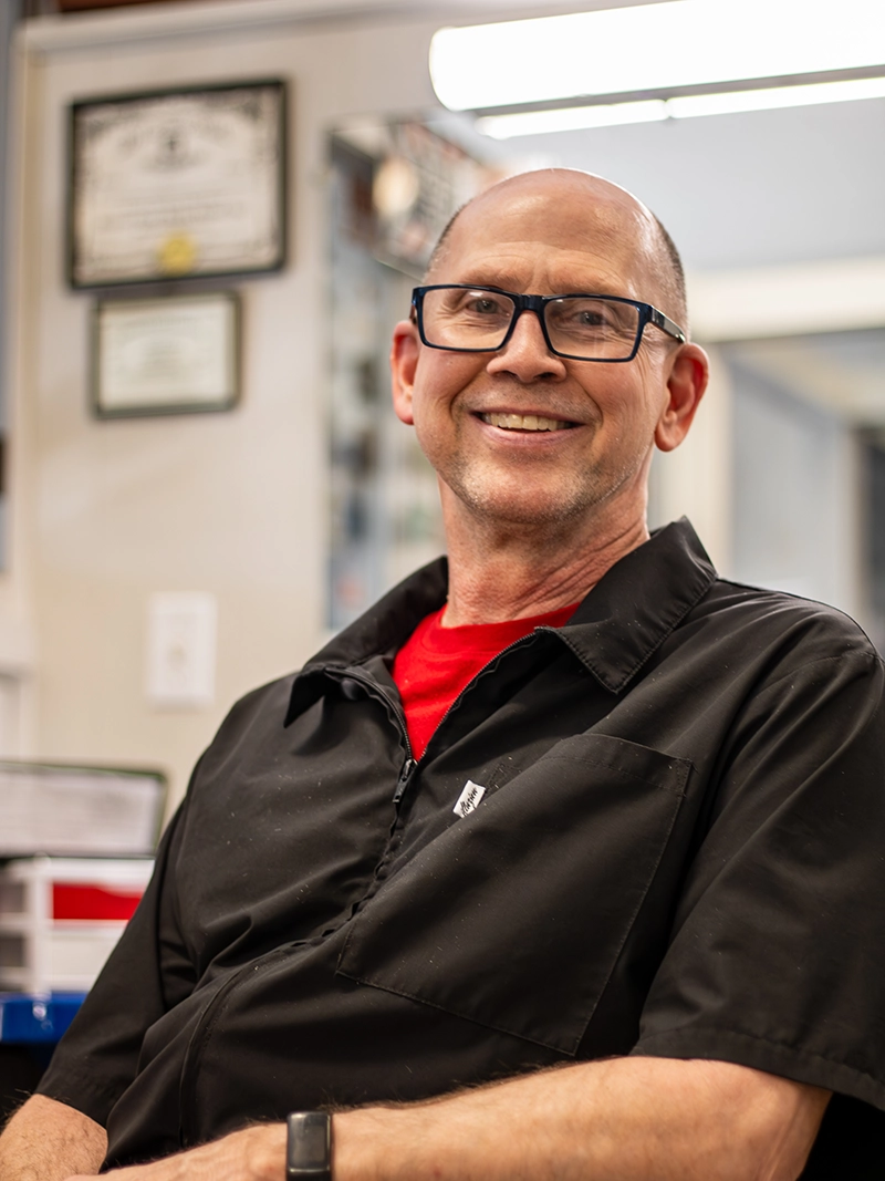 Portrait image of Michael. A barber at the Quaker Village Barber & Style Shop in Greensboro, NC.